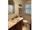 A bathroom featuring a sink vanity, mirror, towels hanging, and a standard toilet at 427 Longfellow Blvd, Lakeland, FL 33801