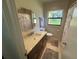 Neutral bathroom with a tub and shower combo, a modern vanity with light countertops, and updated fixtures at 427 Longfellow Blvd, Lakeland, FL 33801