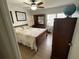 A bedroom with a wooden sleigh bed, matching dresser, and a globe on the dresser by the window at 427 Longfellow Blvd, Lakeland, FL 33801