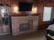 Classic fireplace with brick surround and built in cabinets and shelving on either side at 427 Longfellow Blvd, Lakeland, FL 33801