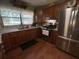 Well-lit kitchen features wood cabinets, granite countertops, and stainless steel appliances at 427 Longfellow Blvd, Lakeland, FL 33801