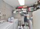A functional laundry room featuring a washer, dryer, storage shelves, and essential cleaning supplies at 427 Longfellow Blvd, Lakeland, FL 33801