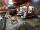 Inviting living room with wood paneling, a brick fireplace, and comfortable seating at 427 Longfellow Blvd, Lakeland, FL 33801