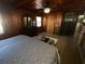 Comfortable main bedroom with wood paneled walls and modern furnishings at 427 Longfellow Blvd, Lakeland, FL 33801