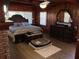 Cozy main bedroom features wood paneled walls and large bed and dresser at 427 Longfellow Blvd, Lakeland, FL 33801