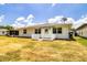 This home features a lovely backyard with a white wooden deck, a perfect space for relaxing and entertaining guests at 4976 Pleasant Hollow Trl, Lakeland, FL 33811