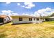 This home features a lovely backyard with a white wooden deck, a perfect space for relaxing and entertaining guests at 4976 Pleasant Hollow Trl, Lakeland, FL 33811
