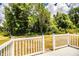 Backyard with a white picket fence, grassy lawn, trees, and views of the surrounding landscape at 4976 Pleasant Hollow Trl, Lakeland, FL 33811