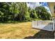Backyard features a white picket fence, grass lawn, trees, and views of the surrounding landscape at 4976 Pleasant Hollow Trl, Lakeland, FL 33811