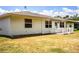 The backyard features a cozy patio, well-kept siding, and a sunny lawn at 4976 Pleasant Hollow Trl, Lakeland, FL 33811