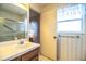 Bathroom features a vanity, toilet, window, shower/tub, and floral wallpaper in a vintage-inspired style at 4976 Pleasant Hollow Trl, Lakeland, FL 33811