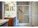 Cozy bathroom with double sinks, walk-in shower, and closet with floral patterned wallpaper at 4976 Pleasant Hollow Trl, Lakeland, FL 33811