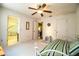 Bedroom with daybed, ceiling fan, and an adjoining bathroom featuring patterned wallpaper at 4976 Pleasant Hollow Trl, Lakeland, FL 33811