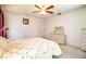 Cozy bedroom with ceiling fan, carpet, floral bedding, and a wicker dresser with mirror at 4976 Pleasant Hollow Trl, Lakeland, FL 33811