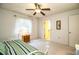 Bedroom features a daybed with green striped bedding, and a window for natural light at 4976 Pleasant Hollow Trl, Lakeland, FL 33811