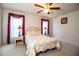 Bright bedroom featuring ceiling fan, floral comforter, and matching lamps at 4976 Pleasant Hollow Trl, Lakeland, FL 33811