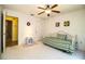 Bright bedroom featuring a ceiling fan, daybed with green striped bedding, and neutral carpet at 4976 Pleasant Hollow Trl, Lakeland, FL 33811