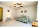 Bedroom with daybed, ceiling fan, and bedside table in a well-lit space at 4976 Pleasant Hollow Trl, Lakeland, FL 33811