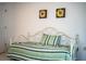 Bedroom featuring a daybed with striped bedding, wall art, and electrical outlets at 4976 Pleasant Hollow Trl, Lakeland, FL 33811