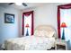 Bright bedroom with floral comforter, two windows, and decorative lamps at 4976 Pleasant Hollow Trl, Lakeland, FL 33811