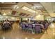 Large community center with tables, chairs, and stage area perfect for events, gatherings, and performances at 4976 Pleasant Hollow Trl, Lakeland, FL 33811