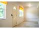 Bright entryway boasts neutral tile floors, multiple windows offering natural light, and a welcoming ambiance at 4976 Pleasant Hollow Trl, Lakeland, FL 33811