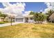 Charming single Gathering home with a well-maintained lawn, a beautiful palm tree, and a screened-in garage at 4976 Pleasant Hollow Trl, Lakeland, FL 33811