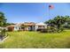 Attractive brick building with white columns, a manicured lawn, beautiful landscaping and a waving American flag at 4976 Pleasant Hollow Trl, Lakeland, FL 33811