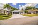 Single-story home showcasing a screened garage, lush front yard, and well-maintained landscaping at 4976 Pleasant Hollow Trl, Lakeland, FL 33811
