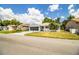 A cozy single-story home featuring a screened garage, green lawn, and inviting curb appeal at 4976 Pleasant Hollow Trl, Lakeland, FL 33811