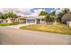 A well-kept home featuring a spacious driveway, attached garage, mature landscaping and inviting curb appeal at 4976 Pleasant Hollow Trl, Lakeland, FL 33811