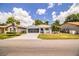 Well-maintained home with lush green lawn and driveway leading to two-car garage, blending comfort and convenience at 4976 Pleasant Hollow Trl, Lakeland, FL 33811