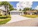 Inviting home showcasing a spacious driveway leading to a two-car garage and a charming, landscaped front yard at 4976 Pleasant Hollow Trl, Lakeland, FL 33811