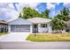 Charming single-story home with a well-manicured lawn and a screened two-car garage, offering curb appeal at 4976 Pleasant Hollow Trl, Lakeland, FL 33811