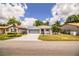 A single-story home boasts a well-manicured lawn, a screened garage, and welcoming curb appeal at 4976 Pleasant Hollow Trl, Lakeland, FL 33811