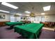 Inviting game room equipped with pool tables, card tables, and classic lighting fixtures for entertainment at 4976 Pleasant Hollow Trl, Lakeland, FL 33811