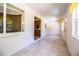Long hallway with tiled floor, white walls and natural light from large windows at 4976 Pleasant Hollow Trl, Lakeland, FL 33811