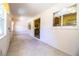 Bright hallway with tiled floor, views of the kitchen, and natural light at 4976 Pleasant Hollow Trl, Lakeland, FL 33811
