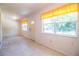 Open living room filled with natural light from large windows and tile flooring at 4976 Pleasant Hollow Trl, Lakeland, FL 33811