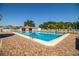 Large outdoor pool surrounded by brick pavers, lounge chairs, and umbrellas for a relaxing resort-style living experience at 4976 Pleasant Hollow Trl, Lakeland, FL 33811