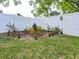 Landscaped backyard featuring a white privacy fence with manicured grass and garden area at 502 Duchess Dr, Lakeland, FL 33803