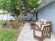 Private backyard patio with outdoor seating, mature landscaping, and ample space for entertaining at 502 Duchess Dr, Lakeland, FL 33803