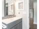 Bathroom vanity showcasing a gray wood grain cabinet with a white quartz counter and decorative backsplash at 502 Duchess Dr, Lakeland, FL 33803
