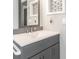 Bathroom vanity showcasing a gray wood grain cabinet with a white quartz counter and a decorative backsplash at 502 Duchess Dr, Lakeland, FL 33803