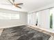 Bright bedroom features a ceiling fan, wood floors and large windows for lots of natural light at 502 Duchess Dr, Lakeland, FL 33803