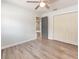 Bedroom featuring hard wood floors, a ceiling fan, closet and connecting door to other areas at 502 Duchess Dr, Lakeland, FL 33803