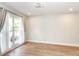 This bedroom has wood floors, neutral paint and a large window letting in lots of natural light at 502 Duchess Dr, Lakeland, FL 33803