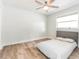 Bedroom showcasing wood floors, ceiling fan, and a bed with a padded headboard at 502 Duchess Dr, Lakeland, FL 33803