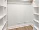 Organized walk-in closet with shelves and rod for storage at 502 Duchess Dr, Lakeland, FL 33803