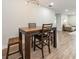 Dining room with a wood table, chairs, bar stools, and a view of the living area at 502 Duchess Dr, Lakeland, FL 33803